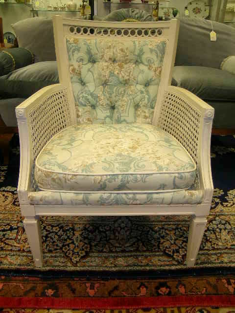 CARVED CREAM COLORED CANE SIDE UPHOLSTERED CHAIR: CARVED CREAM COLORED CANE SIDE UPHOLSTERED CHAIR - Chair measures 33 1/4" high x 24" wide x 27 1/2" deep. Seat height is 16 1/2". There is a 3" tear at the front of seat cushion. Teal design. Generall