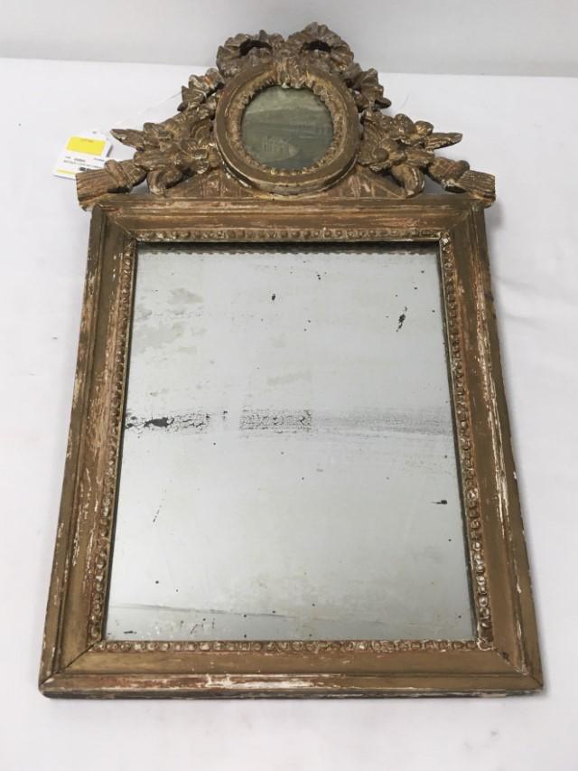 ANTIQUE LOUIS XVI CARVED GILTWOOD WALL MIRROR: Antique Louis XVI carved giltwood wall mirror, measures 29" tall x 15.5" wide and 1.5" deep. Condition: heavy signs of age and wear to finish, repairs to top crest, scattered losses, see images. Weigh