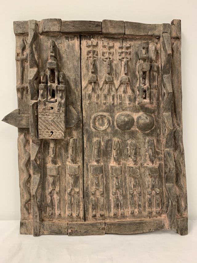 VINTAGE DOGON TRIBE CARVED WOOD GRANARY DOOR: Vintage carved wood granary door from the Dogon tribe, Mali. Measures a total of 23.75" tall x 18.5" wide and 2.5" deep. Condition: a few natural splits to wood, signs of age and use, see images. Weig