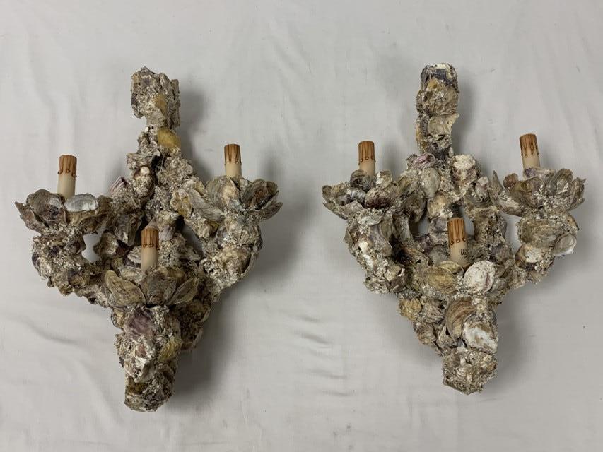 PAIR OYSTER / BARNACLE ENCRUSTED WALL SCONCES: Pair of unique oyster / barnacle encrusted wall sconces. Each one measures 20" tall x 14" wide and 7" deep. Condition: middle wax cup is loose on one sconce, see images. Weight: approx. 16 lbs.