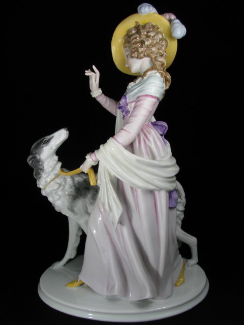 ROSENTHAL PORCELAIN FIGURAL GROUP WOMAN & WOLFHOUND: Rosenthal hand painted porcelain figure of a woman dressed in period clothing with plumes in her hat walking a Russian Wolfhound dog. Stamped on the base Rosenthal with hallmark and incised number 155