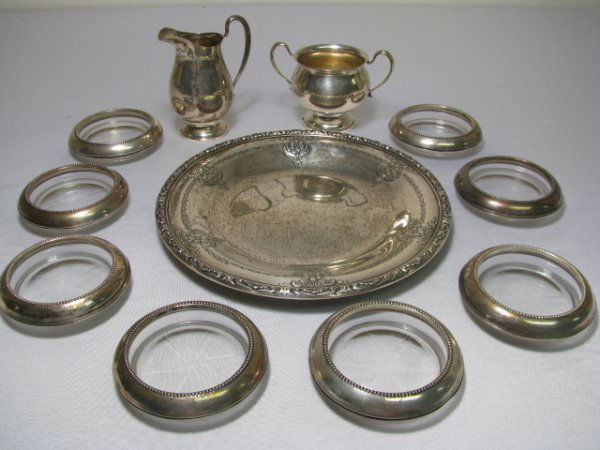 STERLING SILVER TRAY CREAMER & SUGAR COASTERS 11pcs: Group of eleven pieces of sterling silver: round decorative tray 9 1/2" wide, on base is stamped Towle, Sterling, hallmark, 54510. Creamer and open sugar bowl stamped on the base is Sterling, Ellmore,