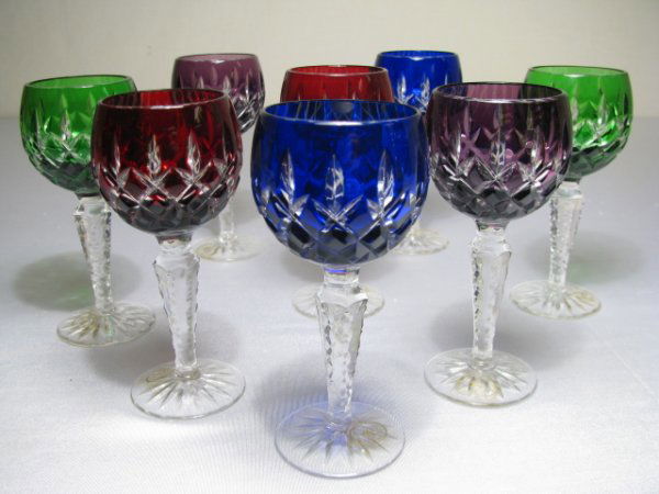 EIGHT CUT to CLEAR CRYSTAL CORDIAL WINE STEMS: Eight Bohemian cut to clear multi colored crystal cordial stem glasses. Made in Hungry by Ajka. Two cobalt, two ruby, two emerald and two amethyst. Several of the glasses have stickers on the base tha