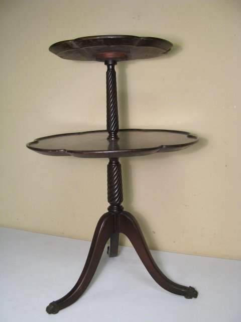 FERGUSON MAHOGANY TWO TIER PIE CRUST TABLE: Mahogany two tier pie crust table on tripod base with brass paw feet. Stamped on the base and retains the original label from the "Ferguson Bros. Co., Hoboken NJ". Table measures 30" tall by 20" wide 