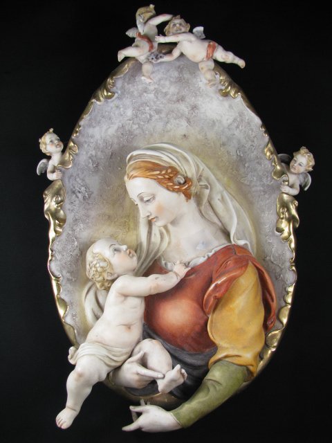 CAPODIMONTE MADONNA & CHILD w/ CHERUBS WALL PLAQUE: Capodimonte porcelain high relief three dimensional wall plaque of Madonna & Child with cherubs. Hallmark on the back with the old Capodimonte mark. Measures 14 1/4" high by 9" wide 2 1/2" deep. There