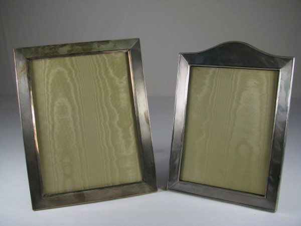 TWO STERLING SILVER PICTURE FRAMES: Two sterling silver picture frames. Both frames have a textured exterior design. First frame is stamped with a hallmark, 925, Industria Argentina along the side. Frame has a velvet easel back and a gl
