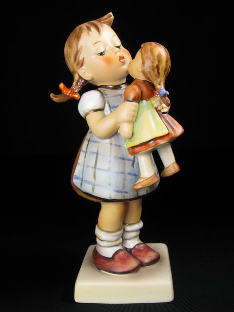 HUMMEL PORCELAIN FIGURINE "KISS ME" TM 5 #311: Hummel porcelain figurine, "Kiss Me," impressed 311 with trade mark 5, Goebel V stamped on base. Measures 6 1/4" tall. No chips or cracks. Crazing is on base. See images. Approx. weight 5 ounces.
