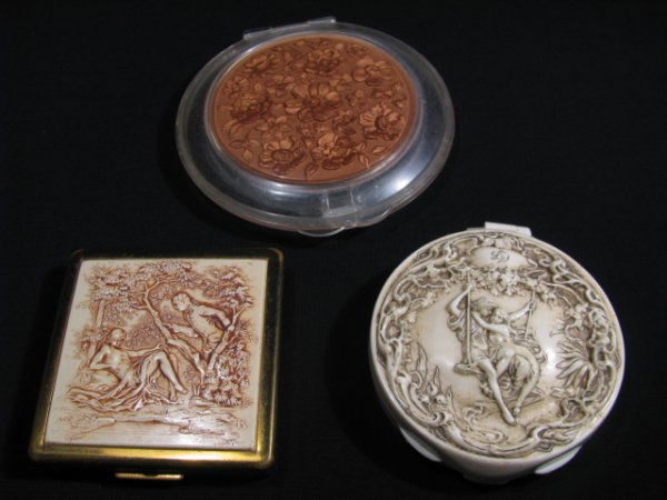 THREE ASSORTED ENGRAVED COMPACTS: A lot of three assorted engraved compacts including a round, plastic, off-white, Lilly Dache compact with Victorian Scene engraved on the lid. Interior is in good condition, exterior is in fair condit