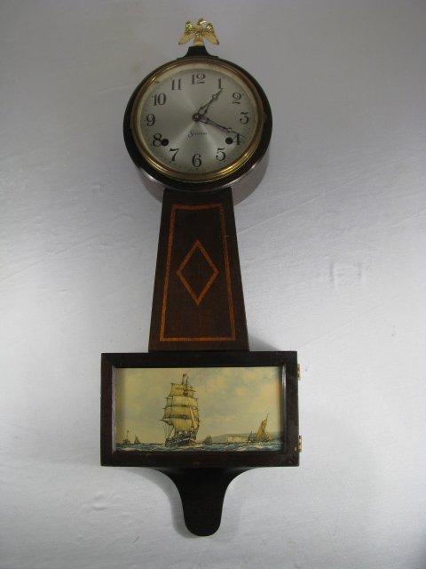 SESSIONS 8 DAY BANJO CLOCK: Time, strike. Has pendulum, no key. Seems to be overwound. Print of sailboat on door. Measures 28" tall x 9 1/2" wide x 3 1/2" deep. Weight is 6 lbs 3 oz.
