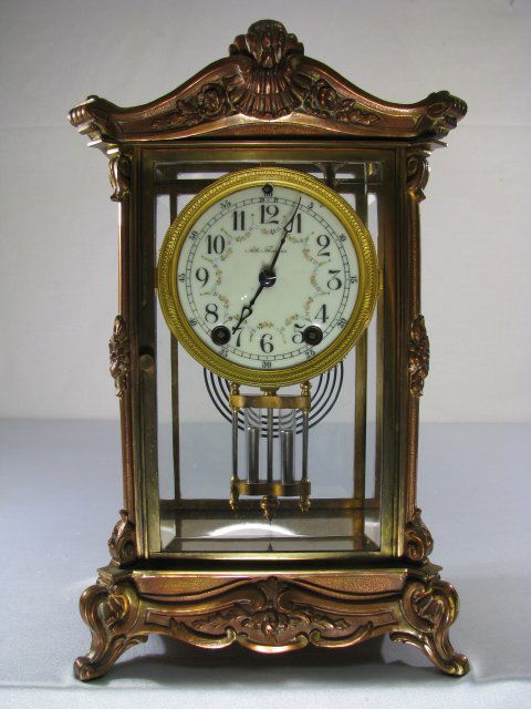 SETH THOMAS EMPIRE NO 9 CRYSTAL REGULATOR CLOCK: Seth Thomas crystal regulator. Appears to be Empire No. 9. Beautiful floral decorated enameled face, time and strike, with mercury style pendulum. Beveled glass panels. Wear to finish. Measures 8" lon