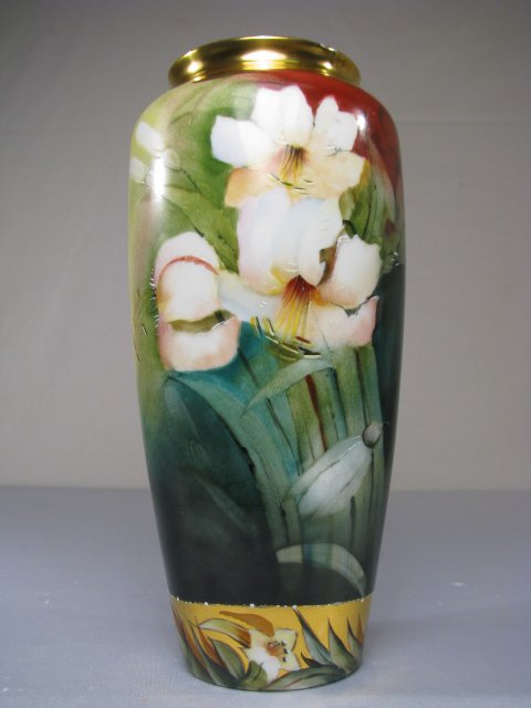 LIMOGES HAND PAINTED GILT FLORAL VASE: Bavarian hand painted vase with floral design and gilt accents. R / C mark on base Measures 9" tall x 4" wide. No chips or cracks. Weighs 1 lb 1 oz.