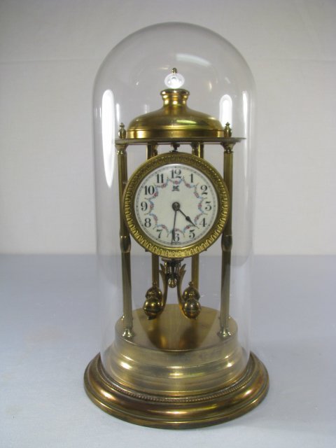 GERMAN SOKOL MONTAG & CO ANNIVERSARY CLOCK: German anniversary clock with floral decorated enamel face. Seems to be overwound. Measures 17" tall x 9" wide. Total weight is 7 lbs 3 oz.