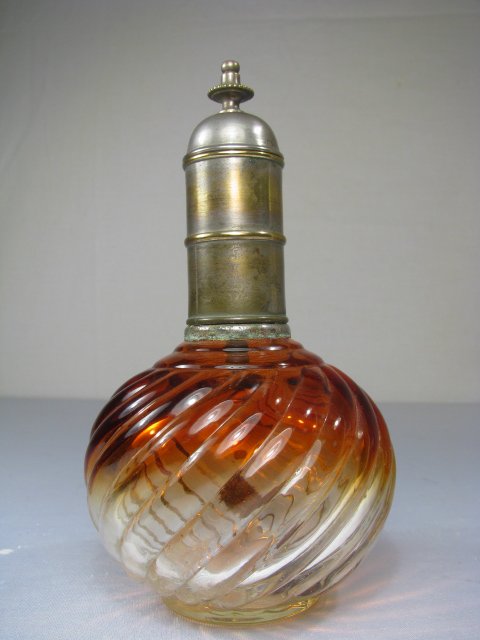 BACCARAT CRYSTAL ROSE TIENTE SWIRL PERFUME BOTTLE: Baccarat Rose Tiente Swirl cranberry to clear bottle. Large bottle with white metal and evidence of gilt cap. Interior perfume wick in place. Paper label on bottom. No chips or cracks. Measures 8" tal