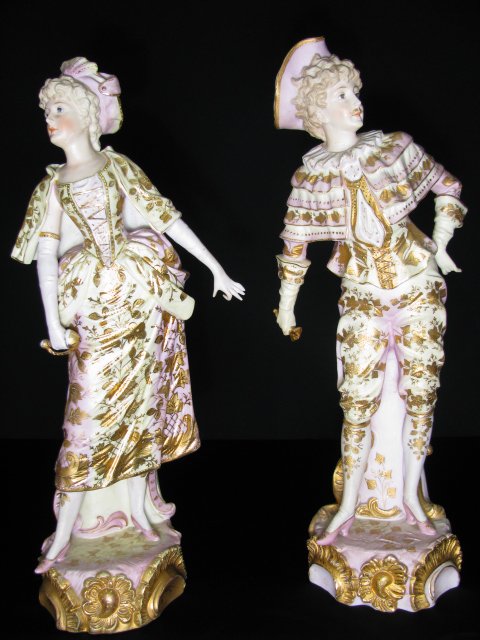 PAIR LARGE HAND PAINTED BISQUE FIGURES MAN WOMAN: Two bisque figures, man and woman, each hand painted in a pastel palette and accented with gold gilt. No maker marks. Woman measures 15 1/2" tall by 6 1/4" wide by 5" deep. Man measures 15 1/2" tall b