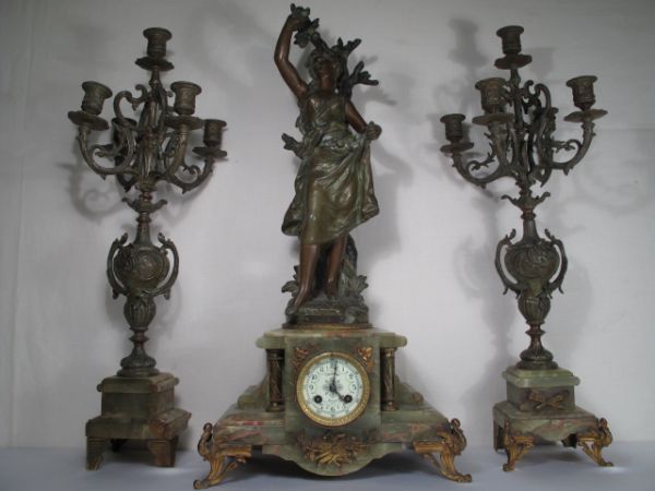 H MOUREAU FRENCH 3pc MANTEL CLOCK & GARNITUR: Chizalet Roanne, French three piece mantel clock set with candelabra garnitures. Spelter figure with bronze finish after Hippolyte Moreau. Signed on base. Plate on front engraved. Time strike with ena
