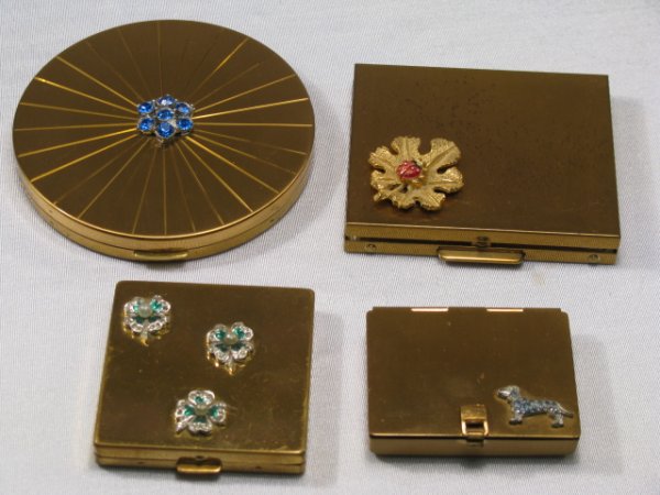 FOUR RHINESTONE AND GOLD-TONED METAL COMPACTS: First is a round Zell Fifth Ave compact with capri blue rhinestone flower on the lid. Interior and exterior are in good condition. Measures 3" by 3". Next is a small rectangular Jules Richard compact 