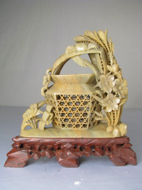 CHINESE CARVED STONE BASKET w SEA LIFE: Chinese carved green soft stone figure of a basket mounted on a craved brown soapstone base. Inside the basket is a fish. Outside of the basket are crabs, flowers and reeds. No maker marks. Measures w