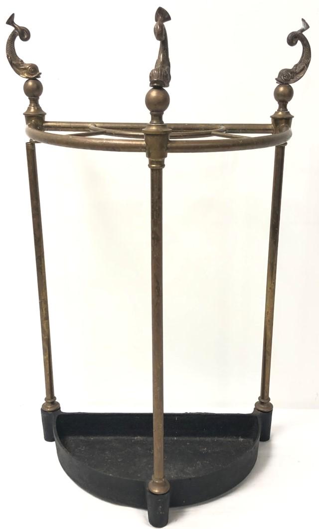 VINTAGE FIGURAL BRASS UMBRELLA STAND: Vintage figural brass umbrella stand with dolphin motif finials and cast iron base. Measures 29" tall x 19" wide and 10.5" deep. Condition: support pole on the left side is stripped at the top connect