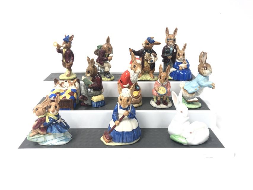 PORCELAIN BUNNY FIGURINES: ROYAL DOULTON ETC. 12 P: Lot of 12 assorted porcelain bunny figurines. Includes 10 assorted Royal Doulton Bunnykins figures, one Herend double rabbit figure and one Beatrix Potter Beswick rabbit. Tallest measures 4.5" tall. A