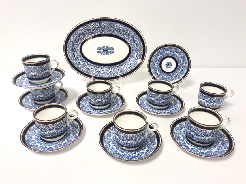 ROYAL WORCESTER "ROYAL LILY" PORCELAIN WARE: 17 PC: Lot of Royal Worcester "Royal Lily" porcelain dinnerware. Includes a 10.75" oval tray, (8) 2.5" tall cups, and (8) 5.5" saucers. Each piece marked on base. Condition: two cups have hairlines to rim, o