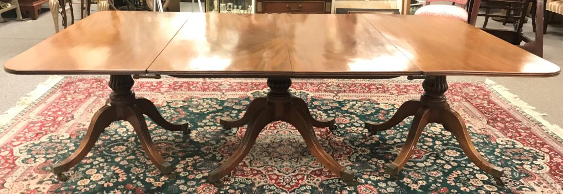 FEDERAL WALNUT TRIPLE PEDESTAL DINING TABLE: Federal period walnut triple pedestal dining table in the manner of Duncan Phyfe. Measures 27.75" tall x 92.75" long and 51.5" wide. Reeded carving on legs as well as table edge. Three sections are jo