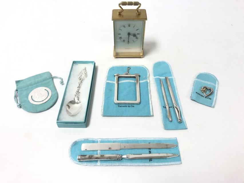 TIFFANY & CO LOT: STERLING SILVER, DESK WARE, ETC.: Tiffany & Co. lot including sterling silver, desk accessories, and more. Includes a sterling silver business or credit card holder, a holiday sterling silver spoon, two sterling silver pens (one by El