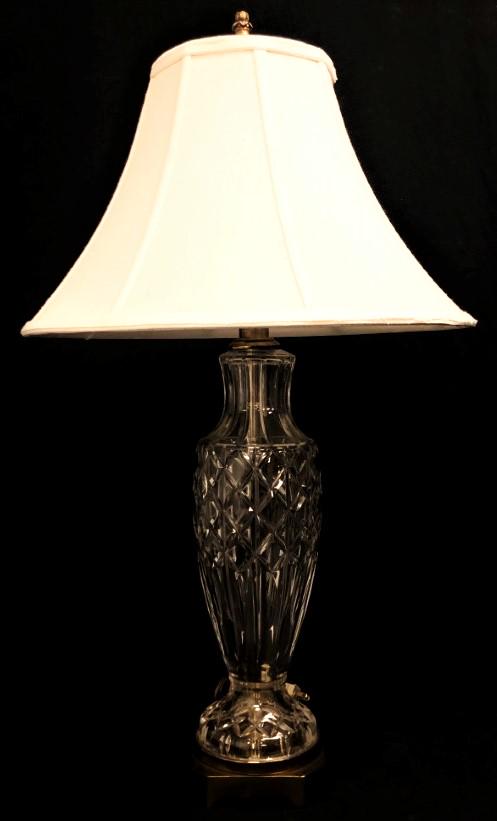 VINTAGE PAUL HANSON CUT CRYSTAL TABLE LAMP: Vintage Paul Hanson cut crystal table lamp measuring 22.5" to socket and 31.5" tall to tip of finial. Off-white fabric shade. Condition: good, see images. Weight: 11.2 lbs.