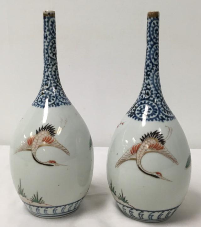 PAIR JAPANESE MEIJI IMARI PORCELAIN BOTTLE VASES: Pair of Japanese Meiji period Imari Tako Karakusa porcelain bottle vases, each measuring 11" tall. Unsigned. Condition: chip to the rim of one, see images. Weight: 2.8 lbs.