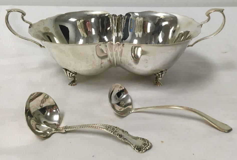 REED & BARTON STERLING SILVER DOUBLE CONDIMENT BOW: Reed & Barton sterling silver double condiment bowl with two Gorham sterling silver sauce ladles. The bowl is hallmarked on base and measures 3.5" tall x 10.2" long (handle to handle). Condition: good
