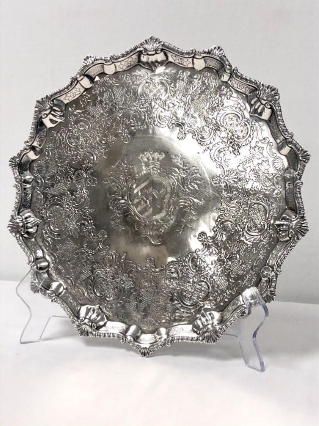 GEORGE III STERLING SILVER SALVER JONES & SCOFIELD: A George III sterling silver footed salver by Robert Jones & John Scofield. Diameter 14.25", height 1.5" . Hallmarked on base for London, 1776. Engraved coat of arms in the center. Condition: minor we