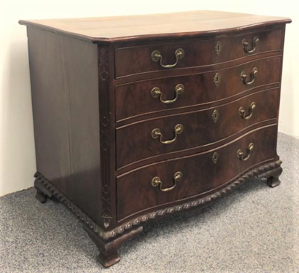 GEORGE III CHIPPENDALE STYLE SERPENTINE FRONT CHEST: George III Chippendale style flame mahogany serpentine front chest of drawers. Measures a total of 33" tall x 42" wide and 27" deep. Elaborate carved edges and corners, locks have been filled in with 