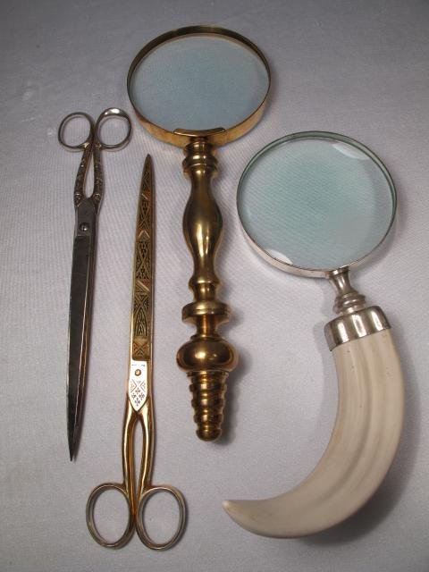 GROUP BRASS MAGNIFYING GLASS SCISSORS 4 PCS: Grouping of two pairs of scissors, gold toned by Toledo and silver toned made in Germany. Both measures 10" long. Sold together with two magnifying glasses. One brass handled at 12" long x 4 1/2" wide