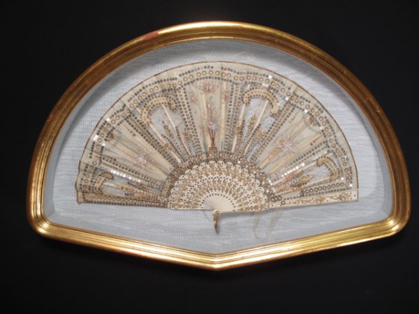 ANTIQUE VICTORIAN FAN BONE FRAME SEQUIN LACE FRAME: Antique 19th Century ladies fan with a bone frame and elaborate lace fabric with sequins sown in. Fan: 9" x 16 1/4". Gilded wood shadowbox frame: 13" x 21" x 2". Weight: 3.5 lbs. Condition: Good with 