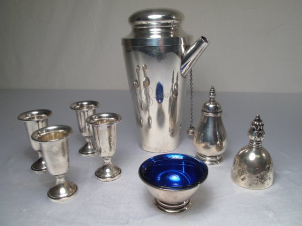 STERLING SILVER MARTINI SHAKER CORDIALS SALT BELL E: Eight sterling silver items including a martini shaker 8" x 5" wide. Four cordial stems, a cobalt blue glass lined salt cellar (2 3/4" wide), a salt shaker and a bell. All in generally good condition 