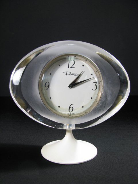MID CENTURY DAUM FRANCE CLOCK ON STAND: Retro Daum France clock on stand. Condition is good except for minor discoloration to the face and a tiny burst glass bubble on the edge. Clock is battery operated and running. Circa 1970's to 1980's