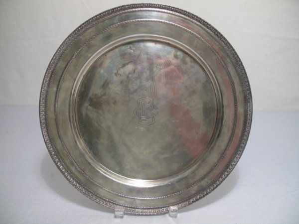 STERLING SILVER SERVING TRAY ROUND: Hallmark on back. Surface scratches with some pitting. Measures 13" wide. Troy weight: 23 oz. Shipping weight is 1 lb 7 oz. (UPDATED: 06/19/09 to correct troy weight to 23 oz.)