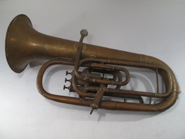 ANTIQUE FRENCH BRASS MUSICAL INSTRUMENT TUBA HORN: Antique French baritone musical instrument made by Couesnon and Company of Paris, France circa 1900. Height: 28". Width: 15" at widest point. Weight: 7.6 lbs. Condition: Worn and dented with parts mis