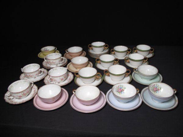 43 PIECES LIMOGES PORCELAIN BOULLION AND TEA CUPS: 43 pieces of Limoges, France porcelain including two-handled boullion bowls, tea cups, and saucers. Late 19th Century and early 20th Century. Lot comprises: 4 boullion bowls decorated with a floral pa