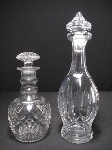STUART AND WATERFORD CUT GLASS CRYSTAL DECANTERS: Two cut and polished glass decanters: One Waterford, the other Stuart Glass. Both cut and polished crystal. Waterford decanter: 13 1/2" tall and 4 1/2" wide at his widest point. Stuart decanter: 9" ta