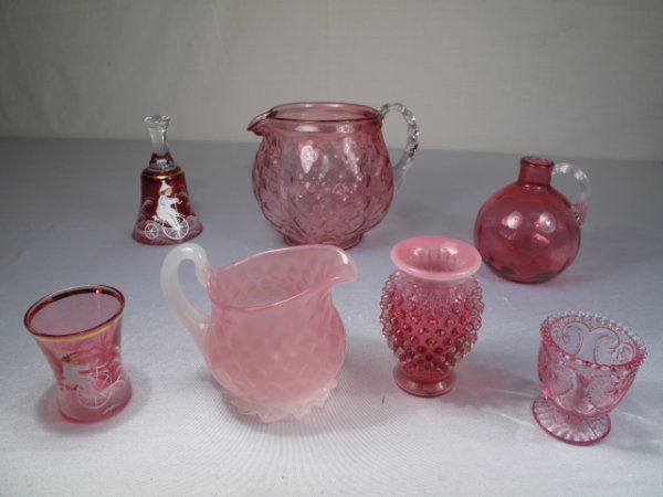 CRANBERRY AND PINK GLASS - 7 PC: Seven pieces of cranberry and pink glass consisting of: a pitcher with quilted design and applied clear glass handle 5 1/4" tall, a bell and a toothpick holder enameled in the style of Mary Gregory, a