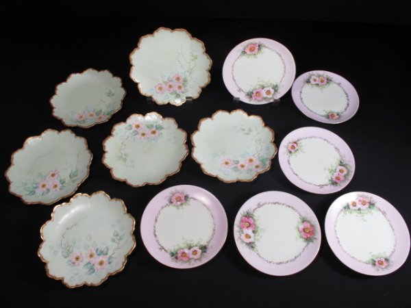 12 PCS ASSORTED PORCELAIN PLATES MALMAISON BAVARIA: 12 pieces of Bavarian porcelain plates. 6 by Malmaison (mark on back) measuring 6 1/2" wide, green with hand painted flowers and gilt rims. The other 6 artist signed hand painted florals at 6" wide. G