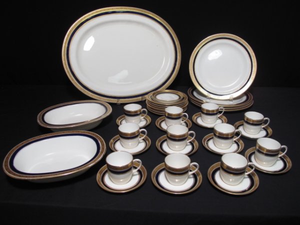 37 PIECES ANTIQUE CAULDON PART SERVICE GOLD & BLUE: 37 pieces English porcelain dinner ware by Cauldon, potters to Her Majesty Queen Victoria, circa 1890 comprising: 11 demitasse cups and 12 saucers; 7 side plates; 4 dinner plates; 2 vegetable dishes; 