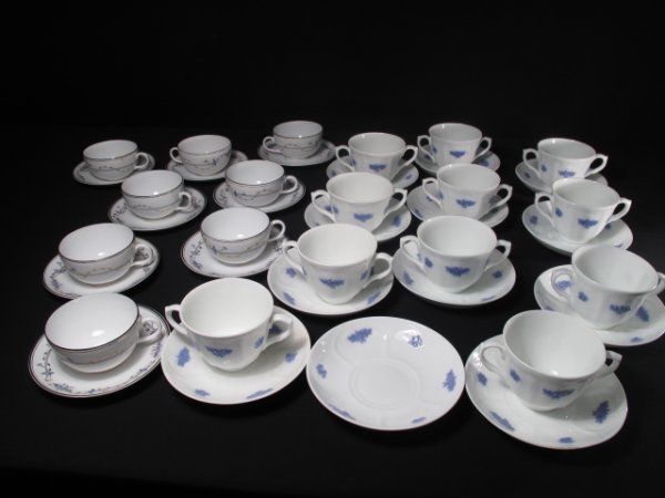TWO SETS PORCELAIN CUPS AND SAUCERS ADDERLY MALMO: Set of delicate bone china cups and saucers made by Adderly's of England. White porcelain with blue floral design and gilt highlights. Cups measure 2 1/2" tall by 3 1/4" wide. Saucers measure 5 1/2" w
