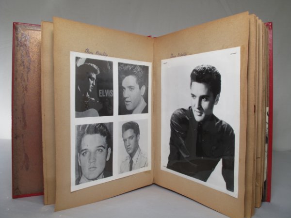 EARLY ELVIS PRESLEY SCRAPBOOK PHOTOS CLIPPINGS: Elvis Presley scrapbook containing a selection of original old publicity photos from the movie Blue Hawaii and newspaper clippings relating to Presley. Size of album: 14 1/4" x 11 1/2" x 1 1/2". Weigh
