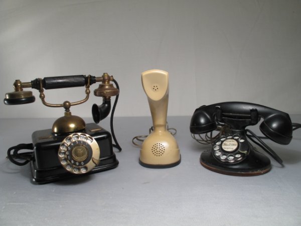 THREE VINTAGE TELEPHONES EARLY 20TH CENTURY: Three vintage telephones including an early Danish model, a mid-century Ericofon rotary dial, and another Bell System rotary phone. Largest 'phone is 8" tall by 9 1/2" wide. Total weight: 14 lbs. Cond