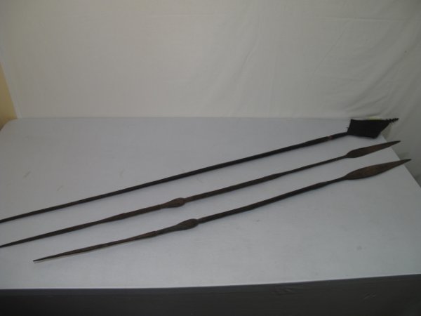 THREE ANTIQUE IRON & WOOD AFRICAN ASSEGAI SPEARS: Three antique iron and wood assegais, probably African, probably over 100 years old. Tallest spear is probably ceremonial and is 80" tall, the blade is 7" wide at its widest point. Total weight: 15.9 