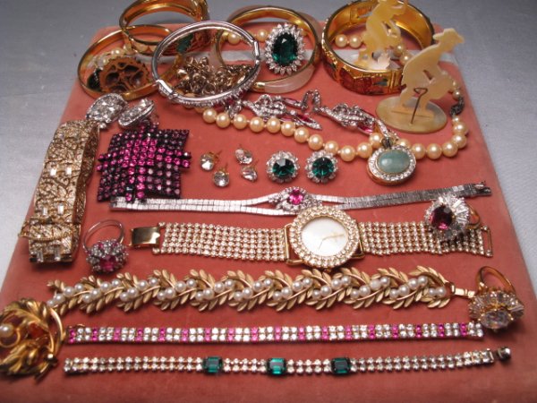 VINTAGE & OTHER COSTUME JEWELRY TRIFARI PANETTA: Vintage and other costume jewelry comprising about 30 pieces including a signed Trifari bracelet, Panetta earrings, a rhinestone brooch, and a pair of chandelier earrings. Various materials and sizes.