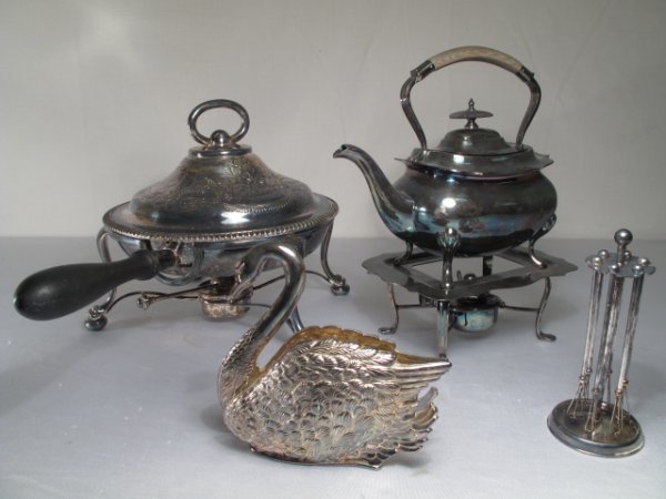 FOUR PIECES DECORATIVE SILVER PLATE TABLE WARE: Four pieces of silver plate including an antique Walker and Hall, Sheffield teapot with stand and burner; an antique James Dixon and Son, Sheffield chafing dish with ball and claw feet; a swan serviet