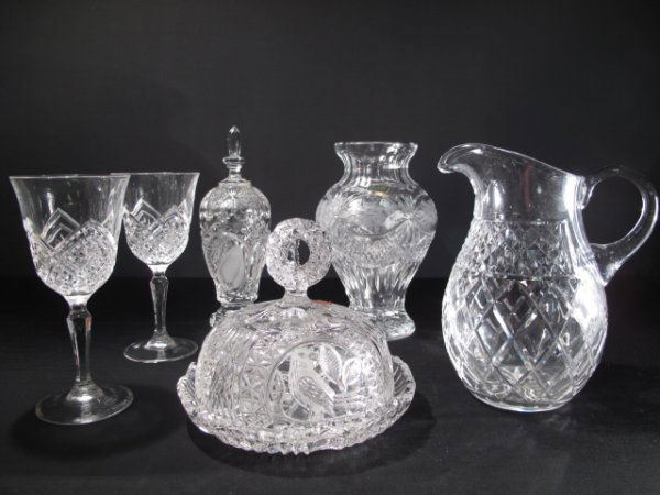 SIX PIECES CLEAR CUT AND PRESSED GLASS TABLE ITEMS: Six pieces of clear glass table wear including: a water pitcher (8" tall); a vase (8 1/4" tall x 5" wide at shoulder); a covered cheese dish (dia. 7 1/2". Height: 6"); a lidded bonbonniere (height: 9"