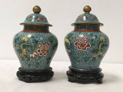 PAIR JAPANESE MEIJI PERIOD CLOISONNE GINGER JARS: Pair of Japanese late Meiji period cloisonne ginger jars with wooden stands. Stands are a close match. Each cloisonne jar measures 7.5" tall, or 8.75" tall on stand. Condition: normal signs of age,